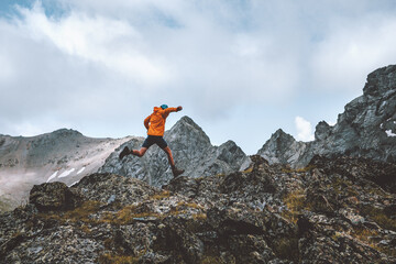 Man trail running in rocky mountains travel hiking adventure activity outdoor summer vacations healthy lifestyle skyrunning extreme sport concept - 483466743