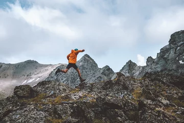 Tuinposter Man trail running in rocky mountains travel hiking adventure activity outdoor summer vacations healthy lifestyle skyrunning extreme sport concept © EVERST