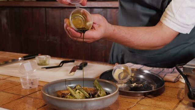 The chef on the stream prepares a dish of fried fish with broccoli and sauce