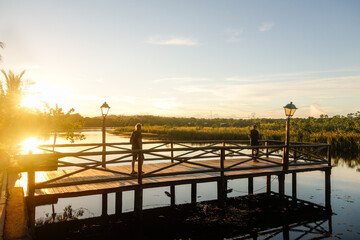 Obraz premium wooden pier on a lake at sunset