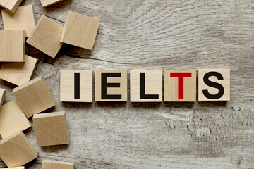 IELTS text on wooden blocks on a wooden background