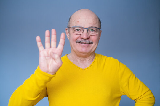 Senior Man Raising Hand, Showing Number Four With Fingers, Counting Something