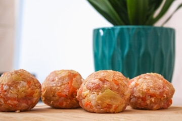 Lazy stuffed cabbage rolls, cabbage, rice on a wooden cutting board on the table. Meatballs with cabbage.
