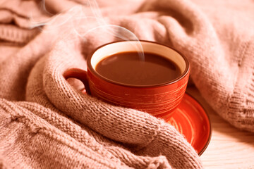 coffee cup, warm cloth on wooden background