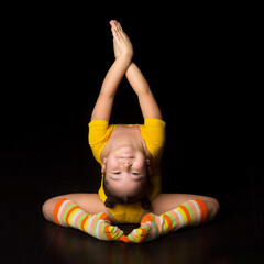 Cute flexible little girl acrobat do acrobatic exercise
