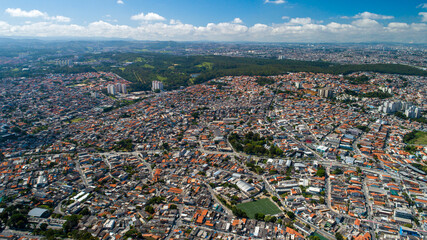Aerial view of Itaquera, Sao Paulo. Residential buildings, avenues and train - obrazy, fototapety, plakaty
