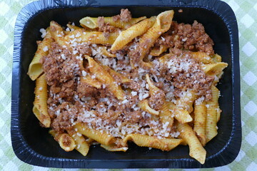 Garganelli is a short egg pasta topped with meat sauce called ragù and Parmigiano cheese