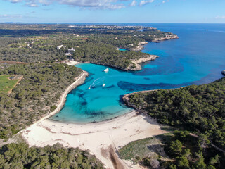Fototapeta na wymiar Panoramic photo of the beach in Mallorca. Beautiful view of the seacoast of Mallorca with an amazing turquoise sea, in the middle of the nature. Concept of summer, travel, relax and enjoy. 