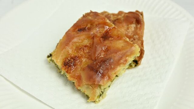closeup of two pieces of spinach pie rotating
