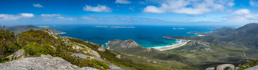 Naklejka premium Wide panoramic landscape of scenic coastline and green hills in Wilsons Promontory, Victoria, Australia