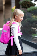  Girl primary school pupil  going to school, education concept. Young schoolgirl with backpack. Lifestyle going to classroom. Children learn smart.  Happy preschool kid. Back to school