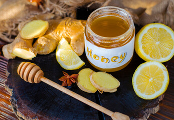 Honey, ginger root and lemon on a wooden board. Folk antiviral remedy