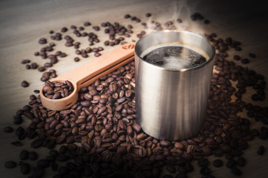 steel coffee tumbler and beans