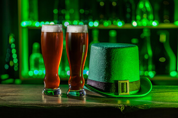 Tall glasses of cold beer, ale on the bar counter. Holiday of Ireland on St. Patrick's Day in irish...