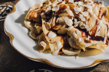 crepes with tahini, date syrup, almonds, bananas