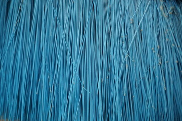 Obraz premium is a macro image of a broom that is blue in color, you can see parts of the broom and the dust attached to it, the background
