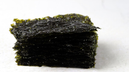 A close-up image of laver against a white background. Concept about healthy seaweed food ingredients.  © Hyejin Kang