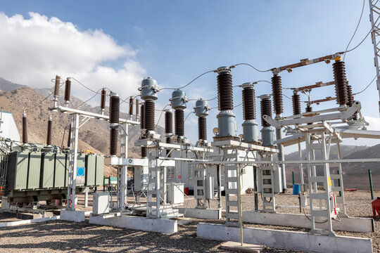 View of the electrical substation (electrical switchyard) for industrial mining plant on the mountain. A substation is a part of an electrical generation, transmission, and distribution system.
