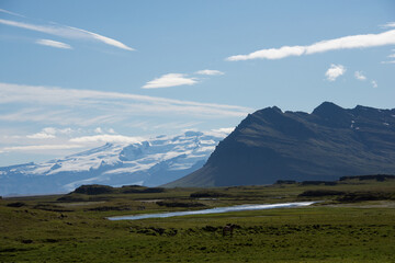 Fototapeta premium Green Grassy mountain Landscape in the highlands. Travel and nature on a beautiful cold day