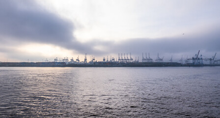 Naklejka premium The cranes at the Port of Hamburg on a misty day - travel photography