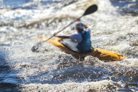 Kayak slalom canoe race in white water rapid river, process of kayaking competition with colorful canoe kayak boat paddling, process of canoeing with big water splash