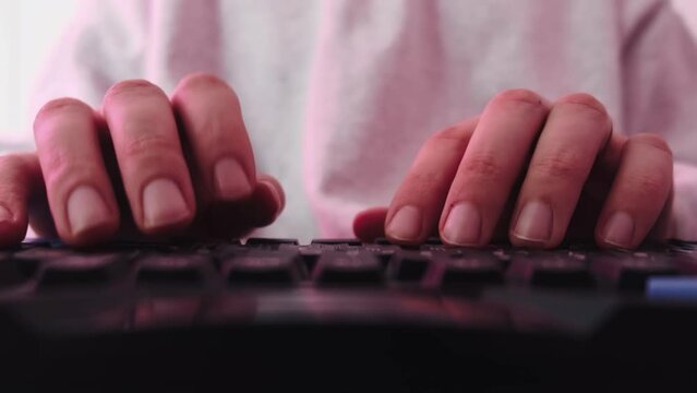 The man quickly typing on a computer keyboard. High quality 4k footage