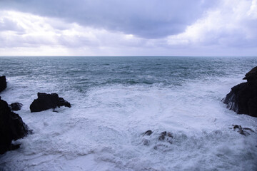 Strong waves hit against the coast of Cinque Terre in Italy - travel photography