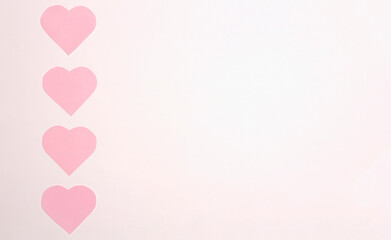 Pink paper hearts on a white background