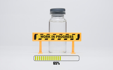 Selective focus picture of covid-19 vaccine with loading bar and work in progress sign. New vaccine...