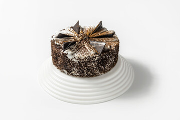 cake with chocolate, sprinkled with chocolate chips, on a tray on a white background