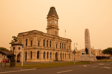 Waitaki District Council building and War Memorial, Oamaru. The sky is cast in an eerie light due...