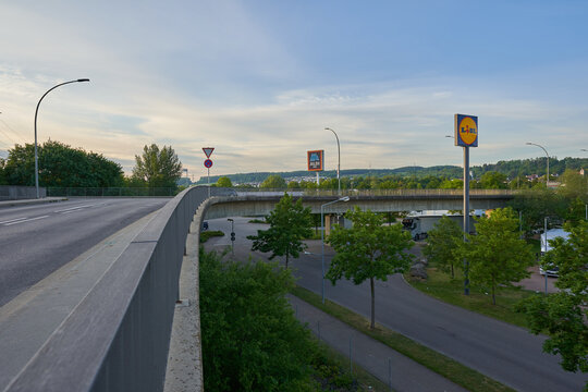 Aldi and Lidl logo stand on a high column, view from the bridge. Altbach, Germany.