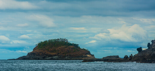 Rock Island over scenic blue sea water.