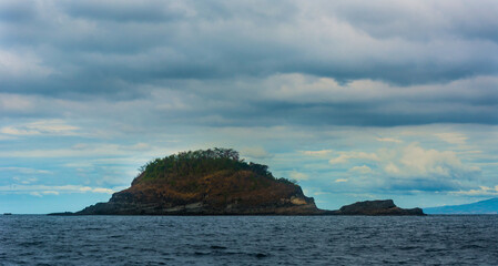 Rock Island over scenic blue sea water.