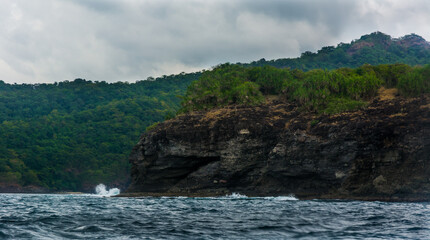 Rock Island over scenic blue sea water.