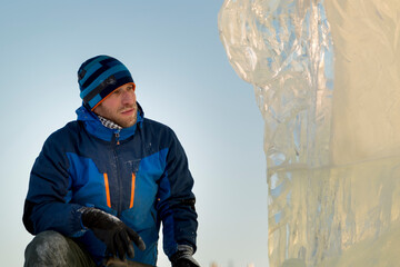 Portrait of a sculptor at work on a figure