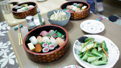 Sushi and sashimi with soya sauce on wooden table in Tokyo