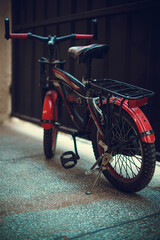 Obraz na płótnie Canvas Red kids bicycle in garage 2