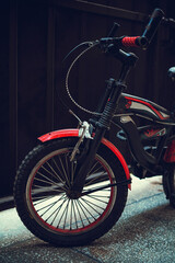 Fototapeta na wymiar Red kids bicycle in garage 1