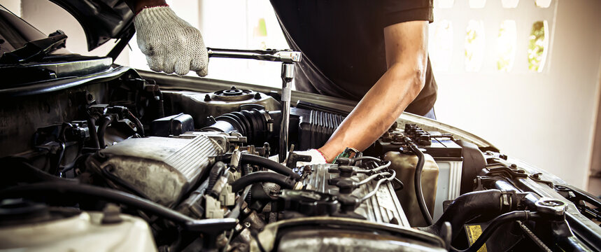 Car care maintenance and servicing, Close-up hand technician auto mechanic using the wrench to repairing change spare part car engine problem and car insurance service support.