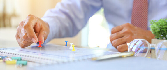Calendar, Close-up hand choose pin on blank desk calendar with office equipment concept of event planner or personal organization for business and appointment reminder and schedule planning.