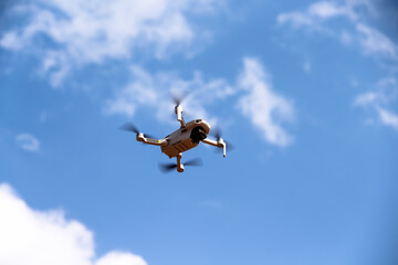 Drone on bright blue sky cloud background with space