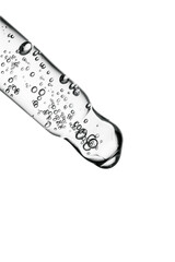 Transparent pipette with cosmetics on a white isolated background.