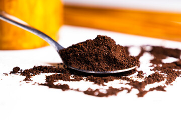 Selective focus and close up image of a spoon of ground coffee powder