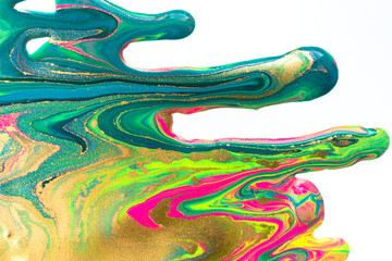 Gold and fluorescent nail polish flowing on white background.