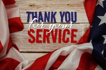 Fototapeta na wymiar Thank You for your Service message with American flag on wooden background