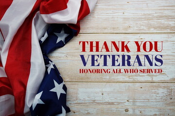 Fototapeta na wymiar Thank You Veterans message with American flag on wooden background