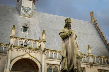 statue of Jacob van Maerlant, Flemish poet and author of the 13th century, in front of the Town hall of Damme, Belgian province of West Flanders, Belgium (only the statue is in focus)