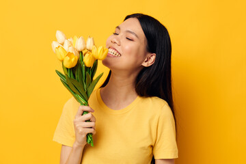 Portrait Asian beautiful young woman with a bouquet of yellow flowers romance isolated background unaltered