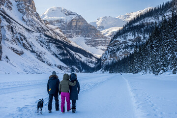 Tourists are walking on the Lake Louise winter trail. Banff National Park, Canadian Rockies. Alberta, Canada.